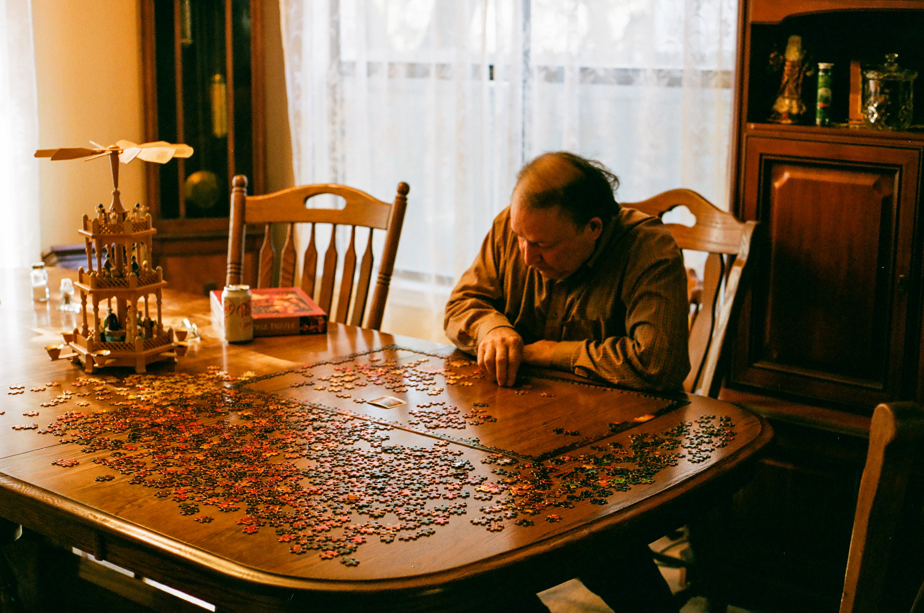 father working on christmas puzzle